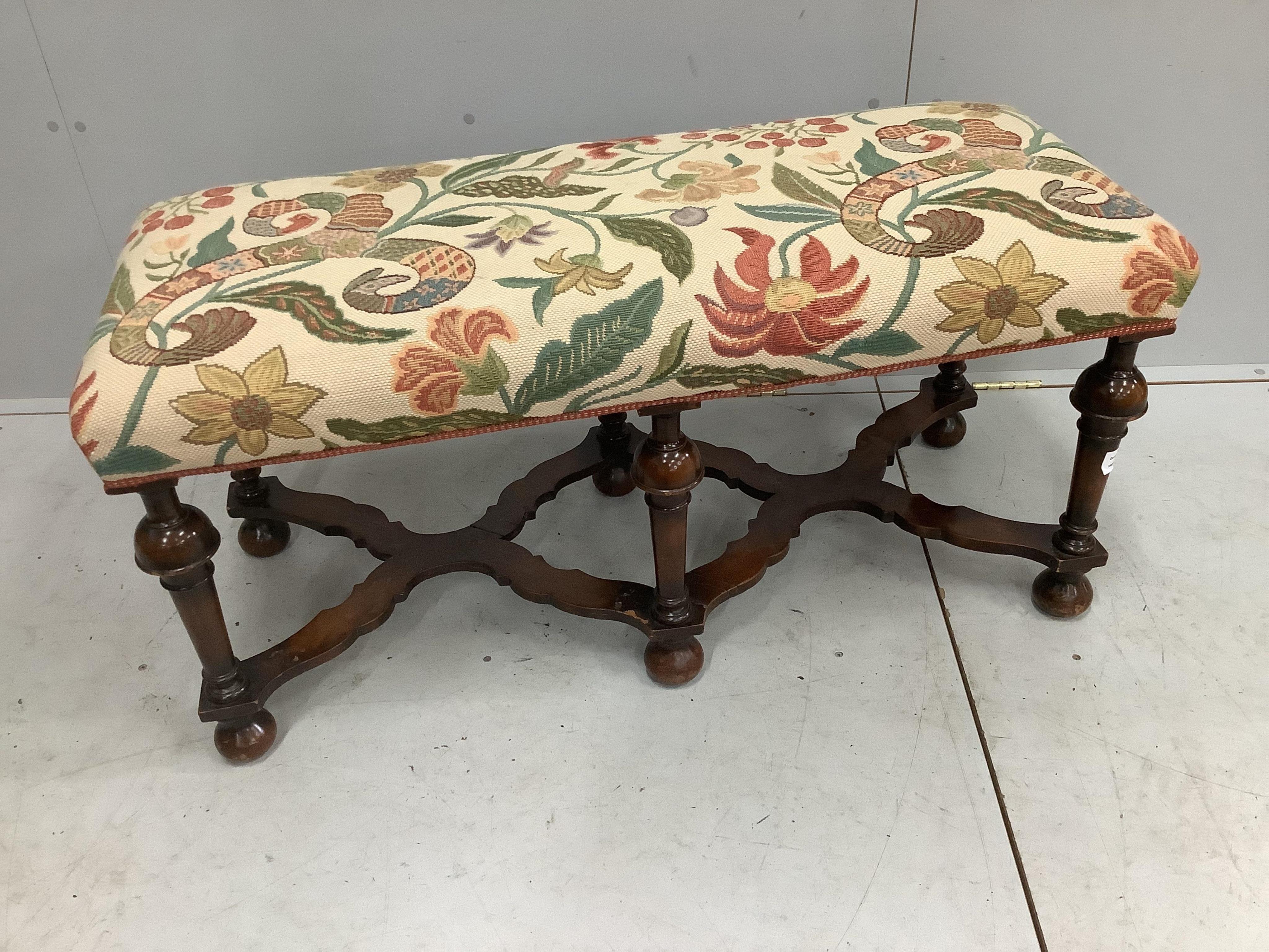 An early 20th century Jacobean Revival walnut dressing stool, width 109cm, depth 46cm, height 51cm. Condition - fair